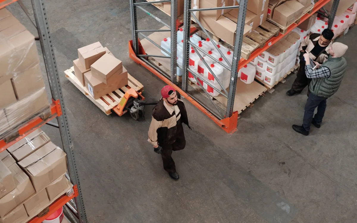 Warehouse team checking inventory between storage racks