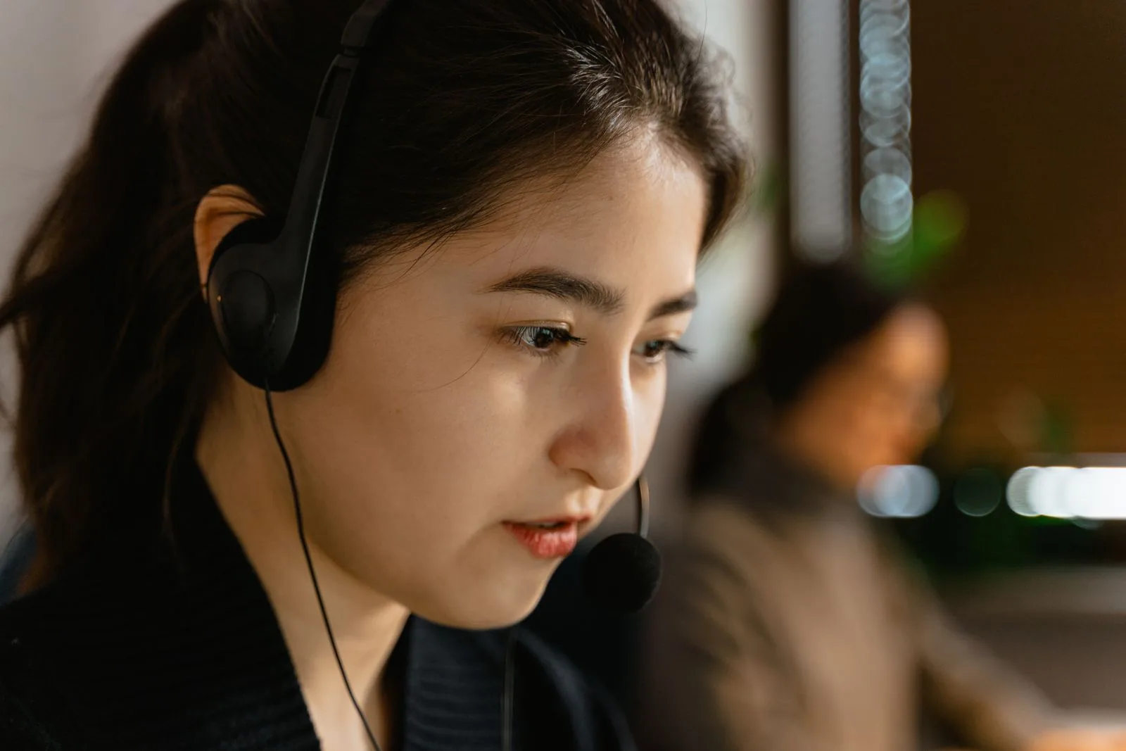 A customer communication professional wearing a headset