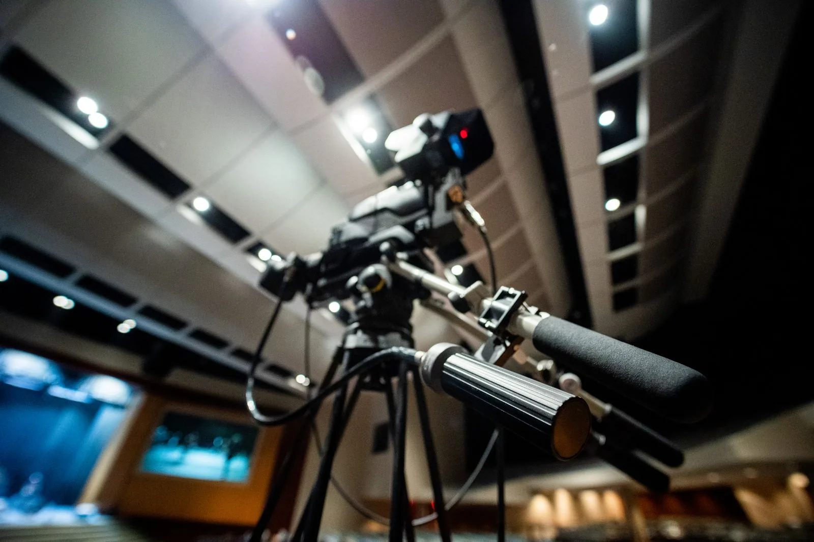 Professional video camera on a tripod in a studio